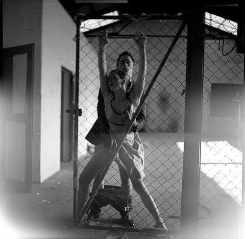 willingsubmission:  pixiejenna:  everything about this just plain does it for me - the setting, the way she’s hanging on to the chain link and you know it’s starting to hurt, the metal digging into her fingers, the way he’s grabbing her breast and