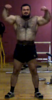 Screen cap of a furry as hell powerlifter. Flexing. Click the