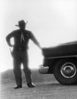 A Nevada sheriff standing against the light from an atomic blast