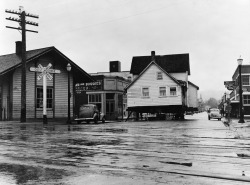 untitled House being moved through the main street of town (population