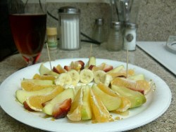 Oranges, apples, strawberries and bananas drizzled in honey.