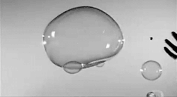 adorabubbblee:  A marble being thrown through a bubble 