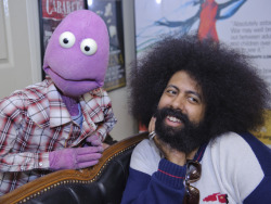 A cute Reggie Watts poses for a pinup calendar while in another
