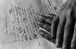  Salvatore Quasimodo’s hands resting on a sheet of poetry -