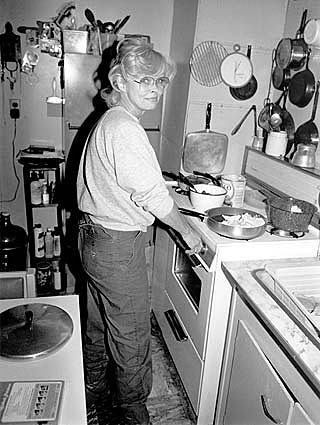 A 1984 photo of Candy Barr in her South Dallas kitchen.. This photo accompanied a number of her obituary notices. She passed away on December 30th, 2005. A lifetime smoker,– she succumbed to pneumonia, at 70 years of age..