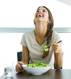  White women laughing alone with salad  