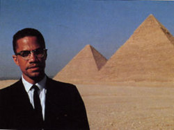  Malcom X standing just outside of The Great Pyramids of Giza,