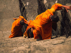 moonlight-beauty:  Buddhist Monks Climbing Angkor, Cambodia 