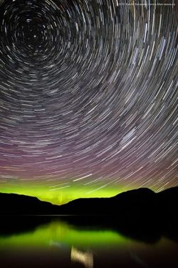 ohscience:   Star trails swirl through candy-colored auroras