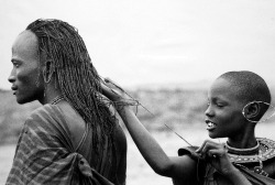 Maasai girl measuring warrior’s hair, Kenya photo by Mirella