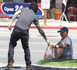      Pete Wentz taking food from a homeless man and then laughing