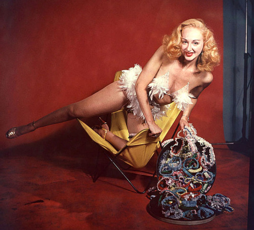 burleskateer:   Lynne O’Neill   aka. “The Original Garter Girl”.. A nice color studio shot of Ms. O’Neill, posing with a hatful of her homemade garters.. During each performance, she would toss a few of these out to lucky audience members! 