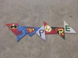 Made it out of wood,paint, and some superhero logos. I’d