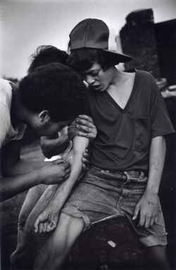  An 11 year-old boy tries heroin on rooftop. The Bronx, New York. 1977.