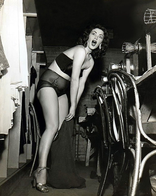 A photographer surprises dancer Blaza Glory in her dressing room, backstage of the ‘FOLLIES Theatre’ in Los Angeles..