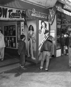 onechair-barbershop: (via LAPL online archive) Young males hover around the large Evelyn West lobby poster, at an unidentified Burlesque theatre..