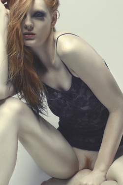 Sexy redhead in a see through top with nothing below.