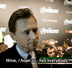 tomhiddlestons:  Tom interrupts an interview to wave to fans.