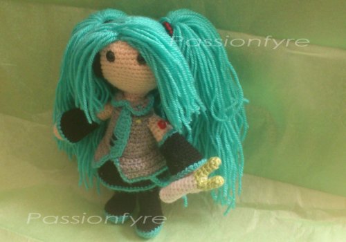 amorningcupofjo:  Submitted by passionfyre: Just wanted to share my completed Miku Hatsune doll :) she took me absolutely AGES because i got lazy and distracted by cross stitch projects. Im soo happy shes done! I was planning on making another vocaloid