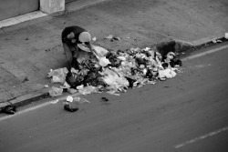 A homeless man picking on garbage