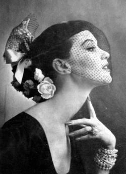 theniftyfifties:  Model wearing a hat with flowers and a veil