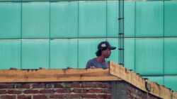 Some construction workers working on a highrise