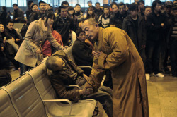 politics-war:  A monk prays for an elderly man who had died suddenly
