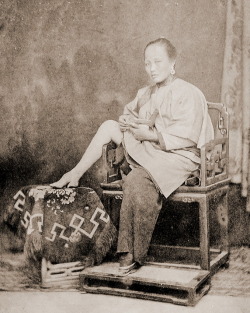 Chinese woman showing her little foot c.1865.