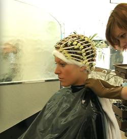 Rolled up, cape closed in the neck, no way back now for John&rsquo;s first perm.