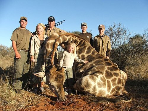 itmeanslovable:  immatinygarnetgem:  tokokomo:  fleursbelle:   Giraffes gunned down for family holiday ‘fun’!A FAMILY poses for a happy holiday snap - standing proudly beside the giraffe they have just shot dead for sport.Tourists like these are paying