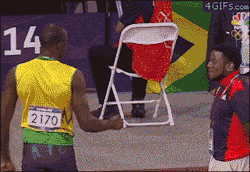  Volunteer at the Olympics reacts to a fist bump from Usain Bolt