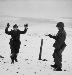 itsjohnsen:  A German soldier surrenders to an American at gunpoint.