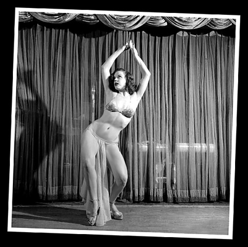 Kalantan  (aka. Mary Ellen Tillotson)  performs on stage at an unidentified nightclub..