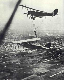 Aeronautic stunt-man Olmer Locklear transferring from one airplane