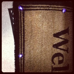 A welcome mat that is pressure activated to light up along its