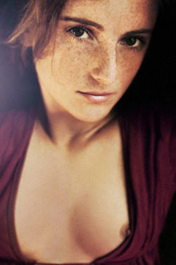 Pretty ginger redhead giving us just a peek at her breasts.