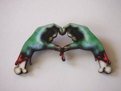 grimlyfiendishfinds:  Wooden zombie love brooch by: http://www.etsy.com/shop/HungryDesigns