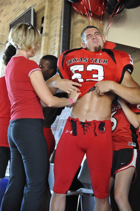 Texas Tech Red Raider football stud trying on a new uniform.