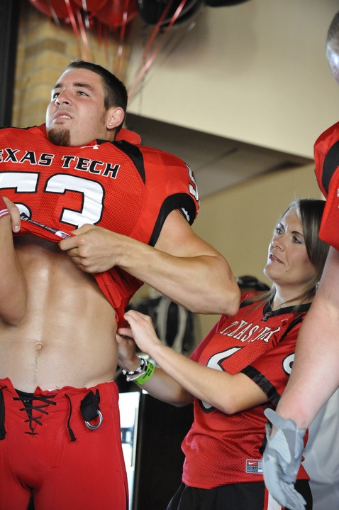 Texas Tech Red Raider football stud trying on a new uniform.