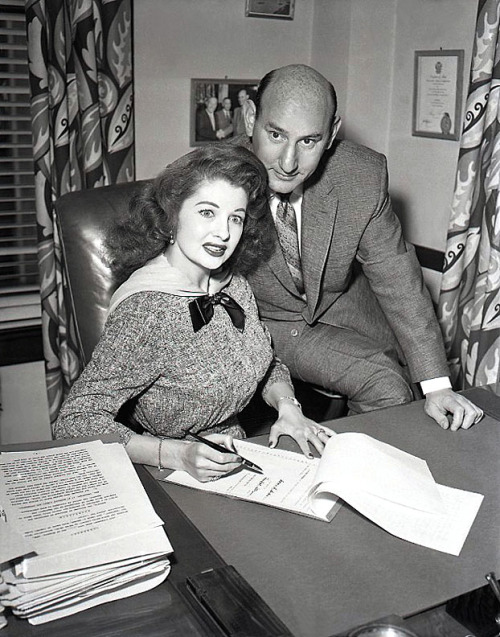 Tempest signs a Million Dollar contract! A vintage press photo from late ‘56, shows Tempest Storm (with Frank Engel) signing a 10-year contract with the 'Bryan-Engel Burlesque Theatres’ chain, worth a sum total of 1 million dollars.. She agree