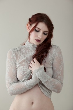 Gorgeous redhead in a lacy, see-through top.  Someone should