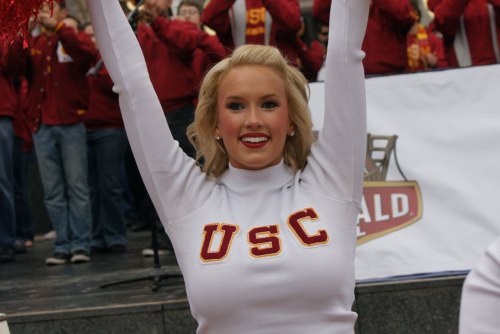 maximuscaligula:  2009/2010 USC Song Girl Shelly LaRue in one of Song Girlsâ€™ classic poses, raising their arms in the air and sticking out their HUGE, perfect, spectacular milk-filled tits at the crowd in their super-tight, sexy, form-fitting, body-hugg