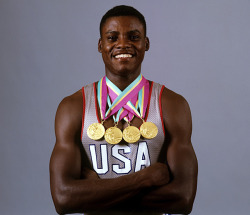 siphotos:  Carl Lewis poses with the four gold medals he won