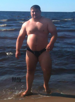 real-thick:  Big guy in speedo. Built like a tank. Real Thick