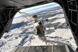 militaryandweapons:  Paratroopers jump toward snow-covered terrain