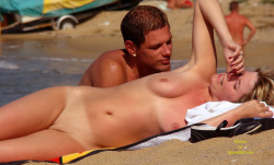 A nicely shaved nudist on the beach.
