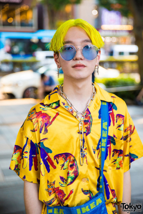 19-year-old Taishin on the street in Harajuku wearing an all over print setup by the Japanese brand 