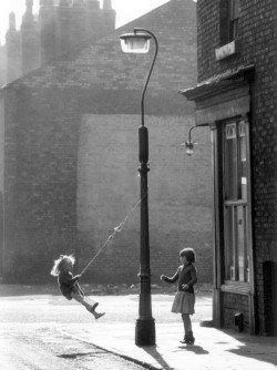   Shirley Baker  Girls swinging on a lamppost”