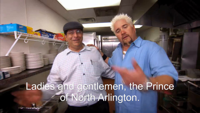 76% sure it's Guy Fieri standing in a kitchen preparing food. Caption: Ladies and gentlemen, the Prince of North Arlington.
