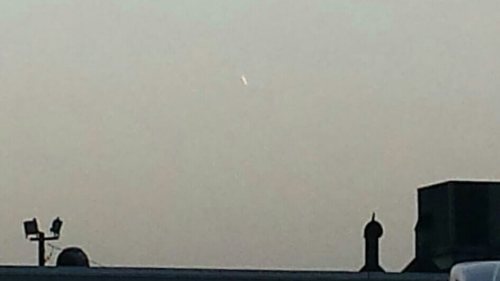 My coworker took a picture of a ufo over a cracker barrel parking lot.